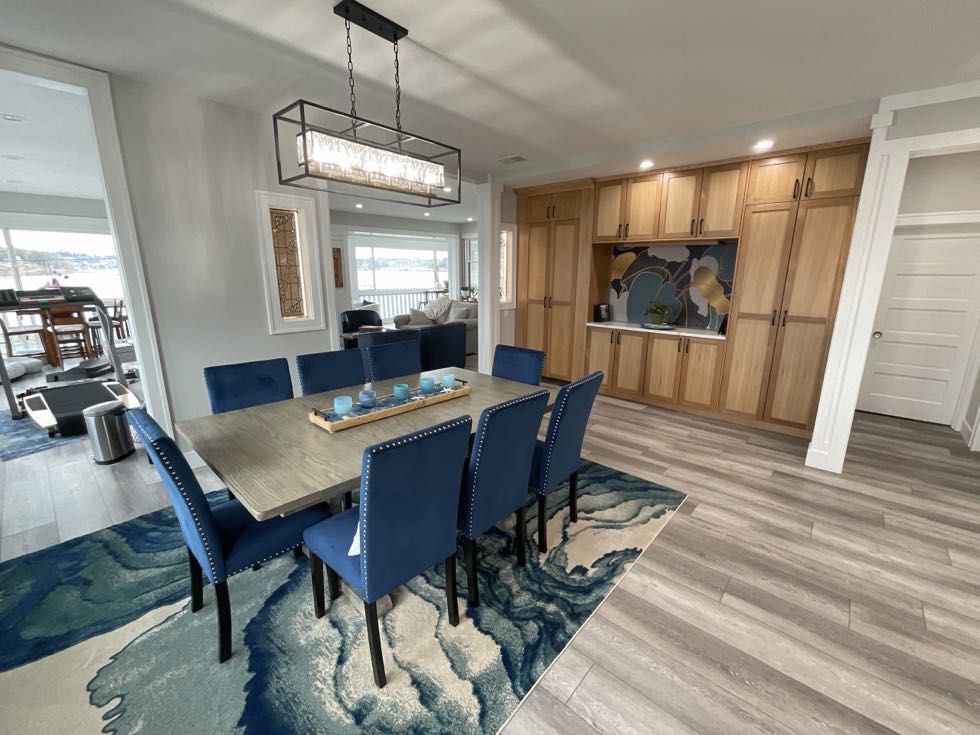 Open dining room with custom built-in cabinetry and linear pendant lighting