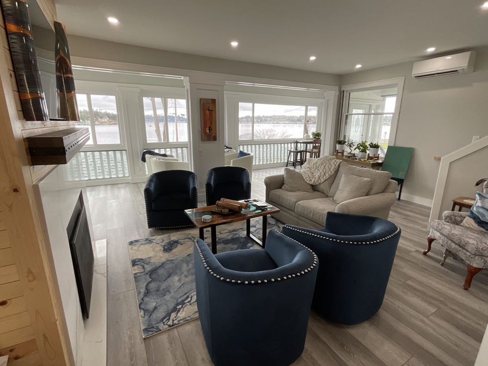 Living room with water view, French doors and new flooring