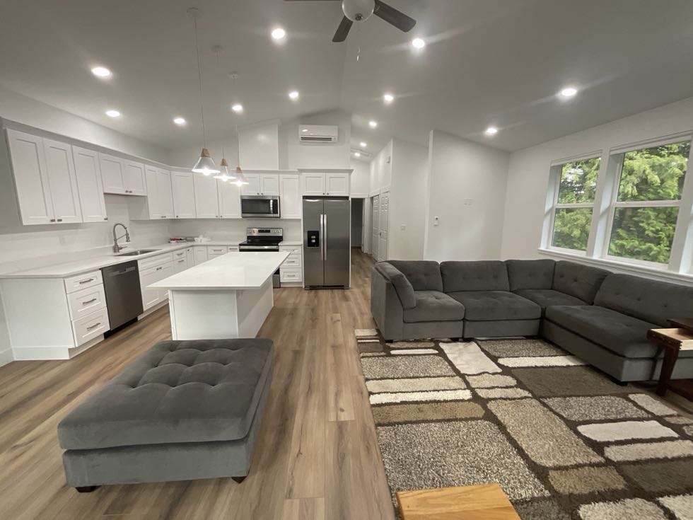 Open concept kitchen and living room with vaulted ceiling