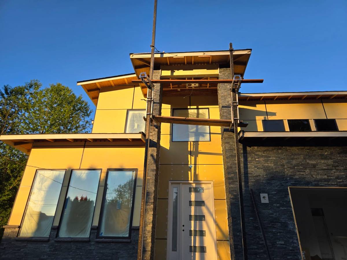 Bothell home exterior at golden hour, showing the two-storey entry tower and stone base